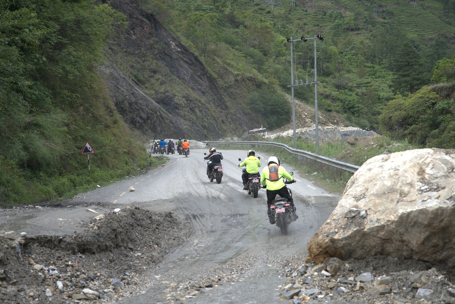 Group of riders neat tatopani riding on gravel and mud road
